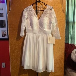 White lace wedding dress . Never worn. New with tags